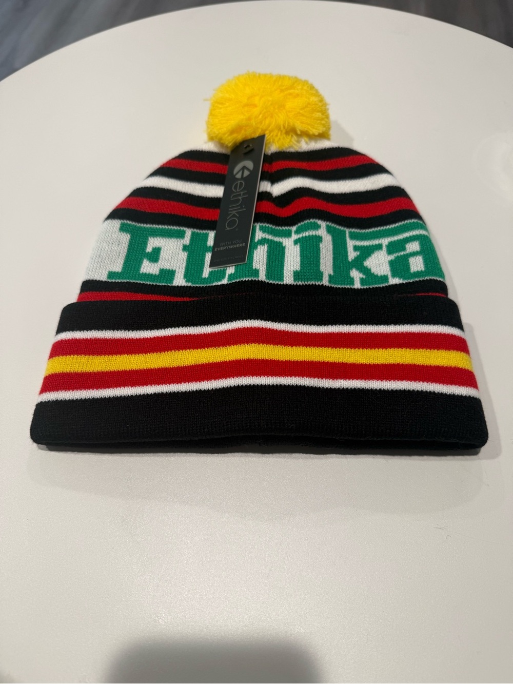 Women’s Striped Pom Beanie Hat in Black, Red, Yellow & Green